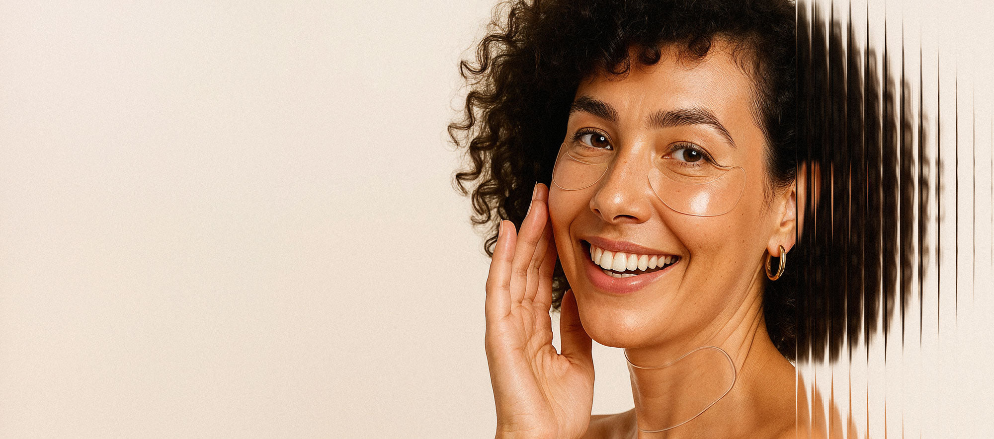 Smiling woman wearing Bare Intent reusable anti-wrinkle patches under eyes and on neck, showing smooth, glowing skin.