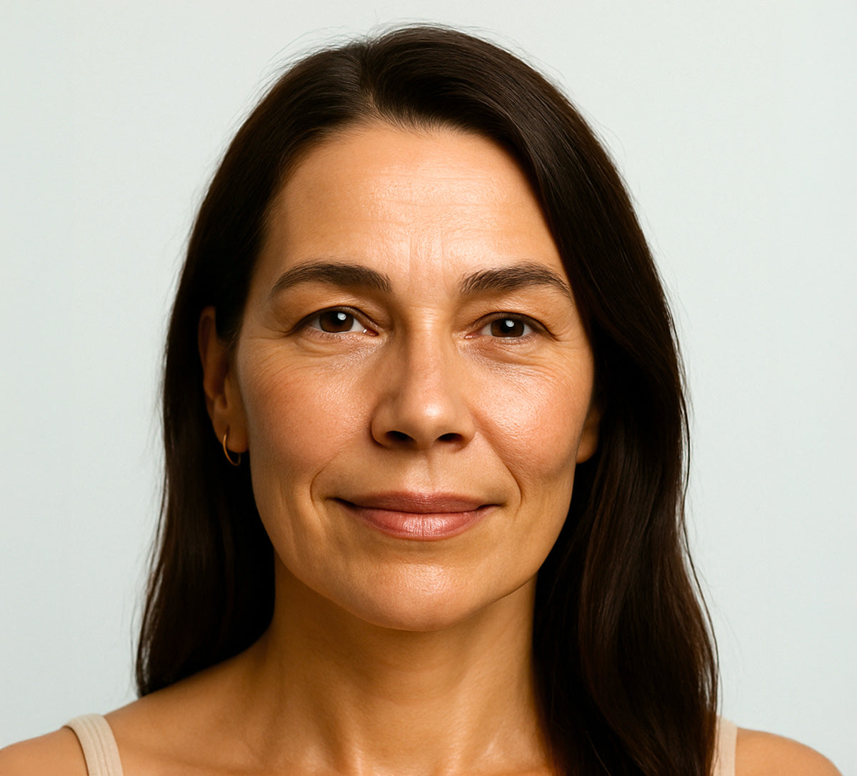 Middle-aged woman with smooth, natural skin and visible fine lines, smiling gently. Showing results after using anti-wrinkle patches by Bare Intent