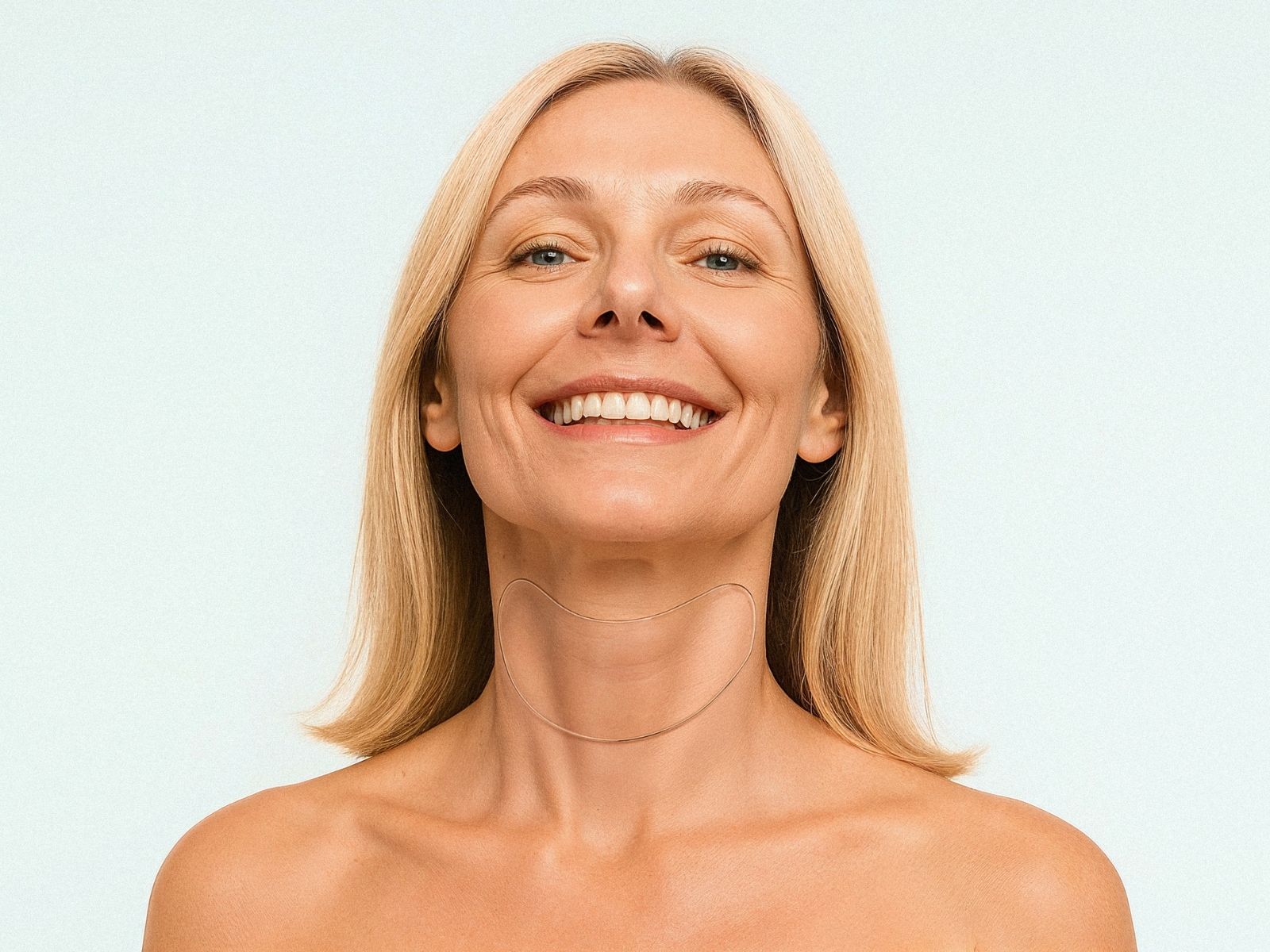 Smiling woman wearing reusable neck patch for wrinkle-smoothing treatment, targeting neck lines, crepey skin and folds – Bare Intent minimalist skincare